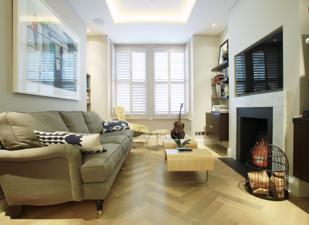 Example of a mid-sized trendy enclosed living room design in London with a standard fireplace