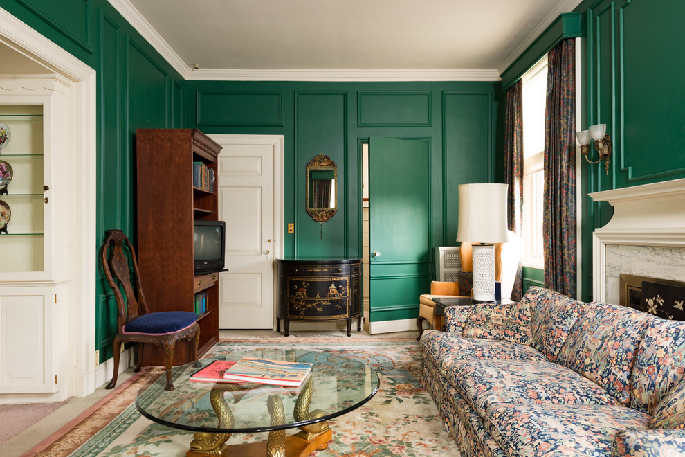 Example of an ornate enclosed living room design in New York with green walls and a standard fireplace