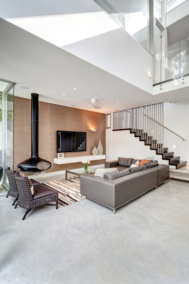 Contemporary formal open plan living room in Sydney with a hanging fireplace, white walls and a wall mounted tv.
