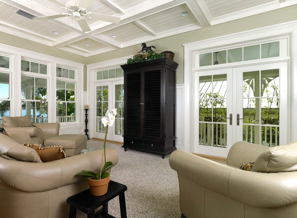 Large beach style open plan living room in Tampa with light hardwood flooring and a concealed tv.