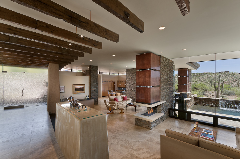 Inspiration for a southwestern open concept living room remodel in Phoenix with white walls and a two-sided fireplace