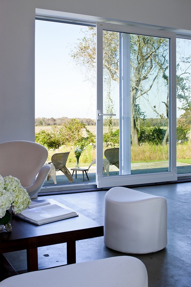 Country concrete floor living room photo in Providence