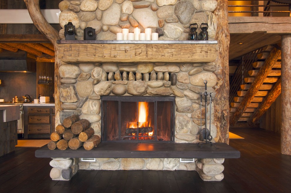 This is an example of a rustic living room in Toronto with a standard fireplace, a stone fireplace surround and no tv.