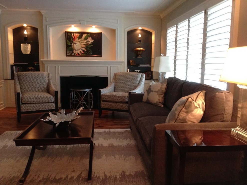 Mid-sized transitional formal and enclosed medium tone wood floor living room photo in Chicago with gray walls, no tv, a standard fireplace and a wood fireplace surround