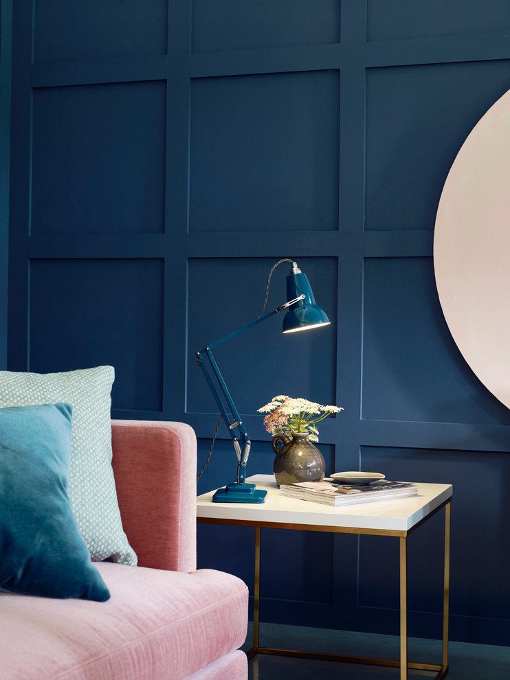 This is an example of a medium sized bohemian formal enclosed living room in Surrey with blue walls, concrete flooring, no fireplace and no tv.