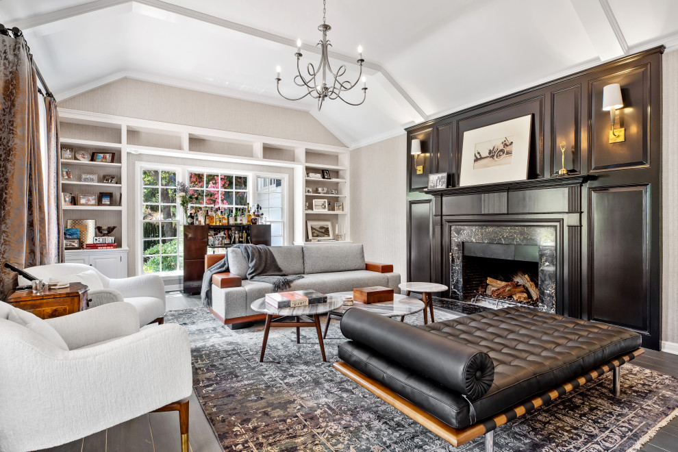 Inspiration for a transitional open concept dark wood floor, brown floor and vaulted ceiling living room remodel in Los Angeles with gray walls and a standard fireplace
