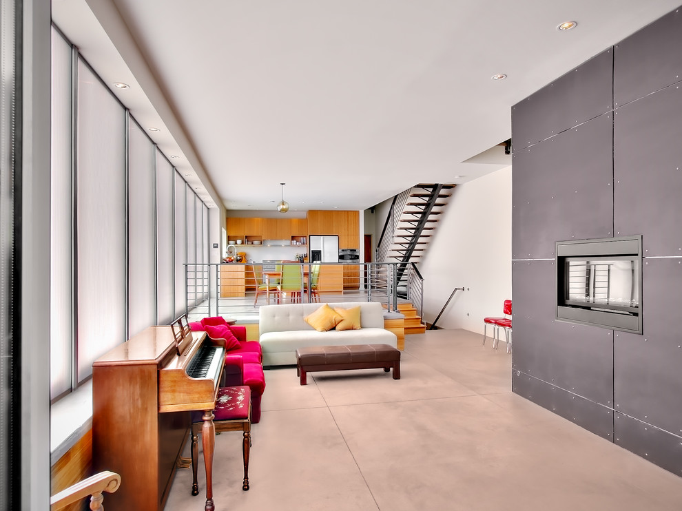 Immagine di un soggiorno minimalista con pavimento in cemento