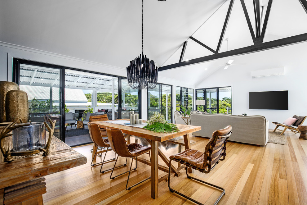 Dining room - large coastal light wood floor and multicolored floor dining room idea in Sunshine Coast with white walls