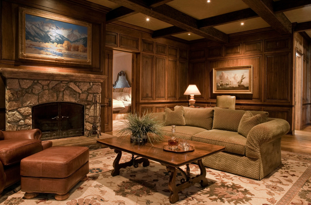 Example of a mid-sized tuscan formal medium tone wood floor living room design in Other with brown walls, a standard fireplace, a stone fireplace and no tv