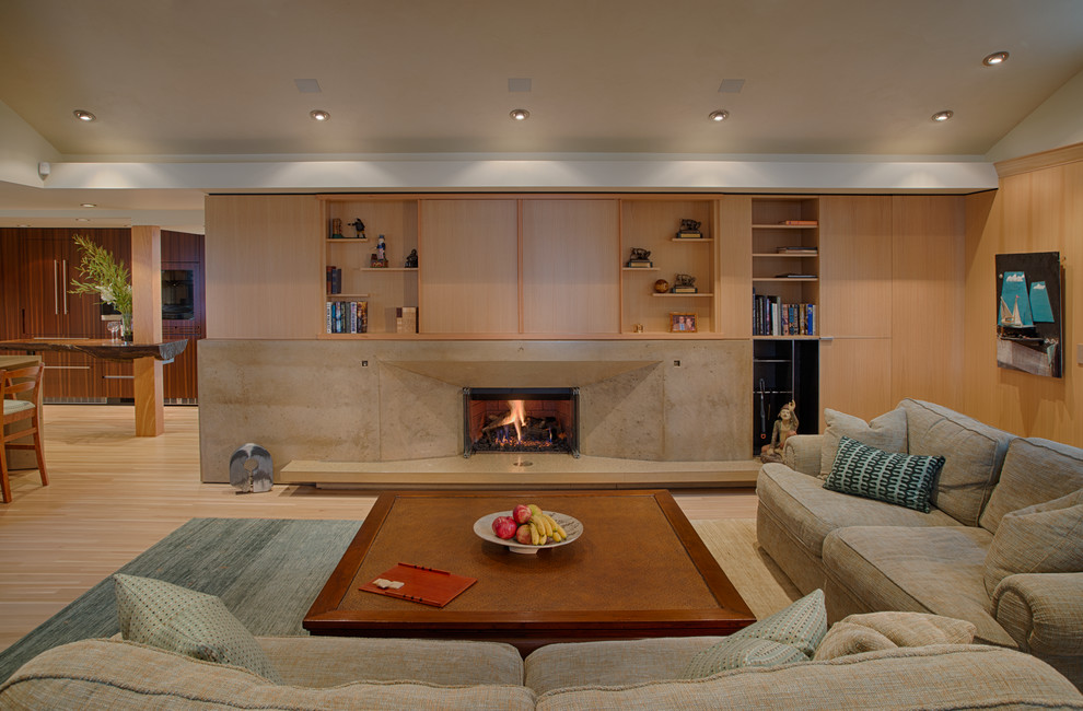 This is an example of a medium sized contemporary open plan living room in San Francisco with yellow walls, light hardwood flooring, a ribbon fireplace, a concrete fireplace surround, a concealed tv and yellow floors.