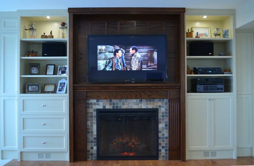 Example of a mid-sized classic open concept medium tone wood floor living room design in Toronto with white walls, a standard fireplace, a tile fireplace and a wall-mounted tv