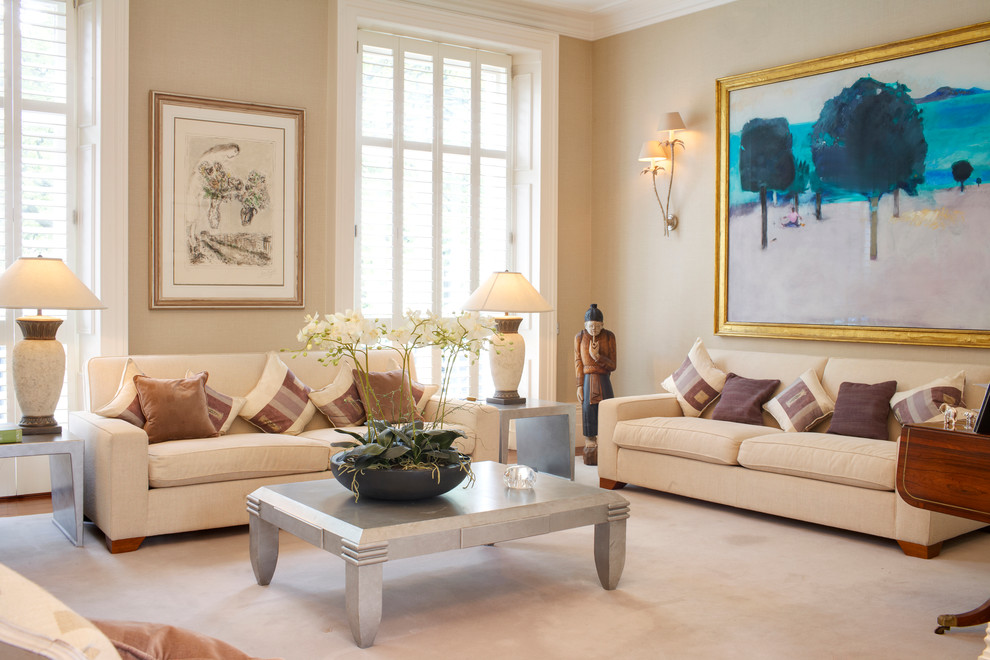 Design ideas for a traditional formal living room in London with beige walls and carpet.