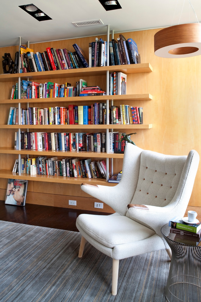 Modelo de biblioteca en casa cerrada contemporánea de tamaño medio sin chimenea y televisor con paredes marrones, suelo de madera oscura y suelo marrón