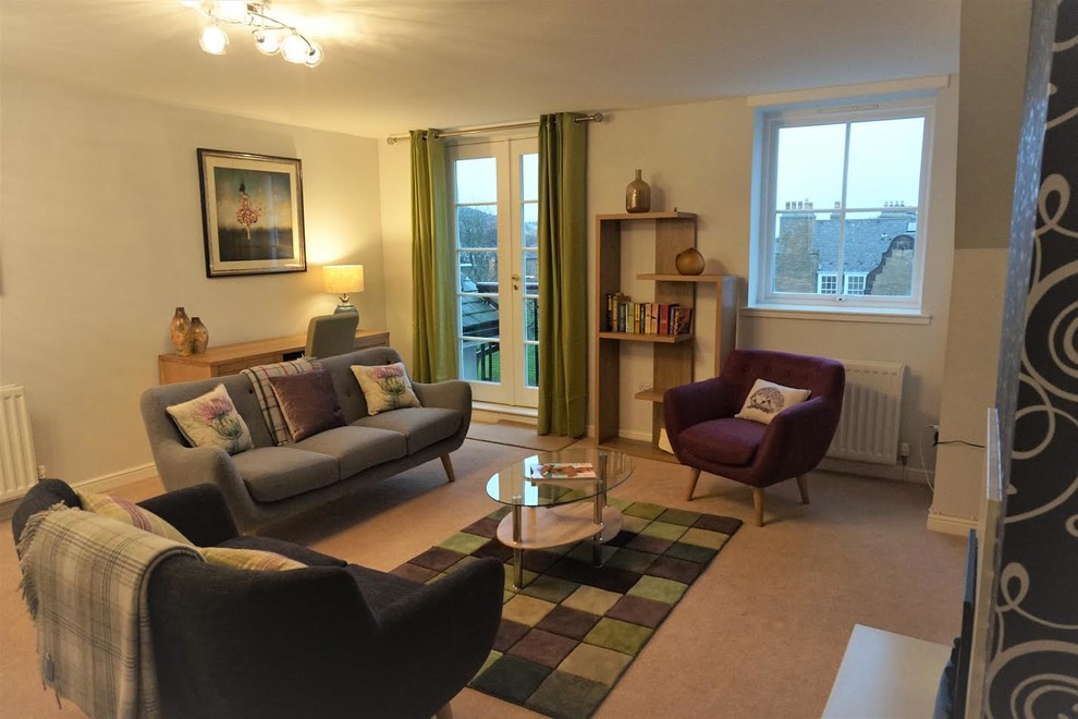 Medium sized contemporary enclosed living room in Edinburgh with a freestanding tv.