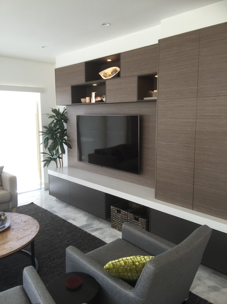 This is an example of a large contemporary living room in Sydney with white walls, marble flooring and a built-in media unit.