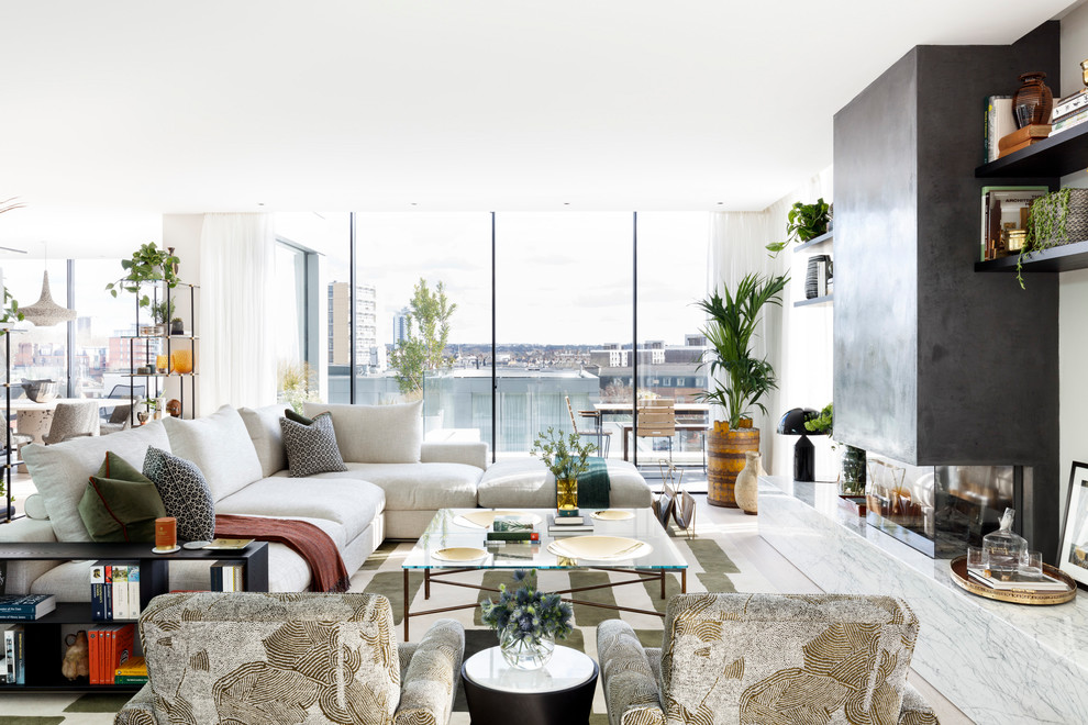 Trendy living room photo in London with white walls and a standard fireplace