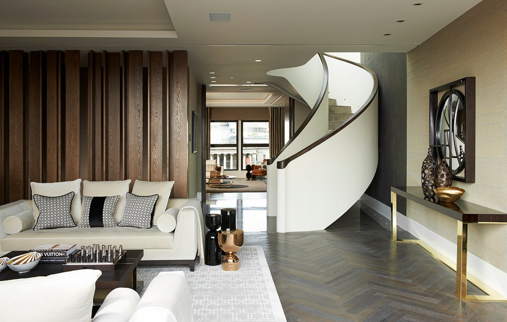 Photo of a contemporary living room in London with beige walls and dark hardwood flooring.