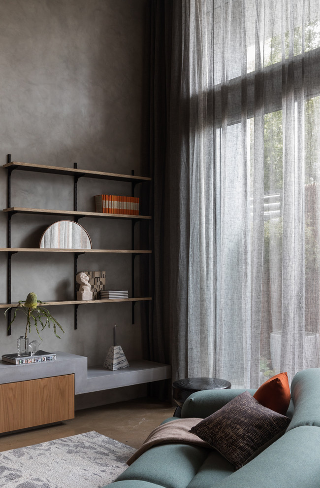 Cette photo montre un petit salon mansardé ou avec mezzanine moderne avec un mur gris, sol en béton ciré et un sol gris.