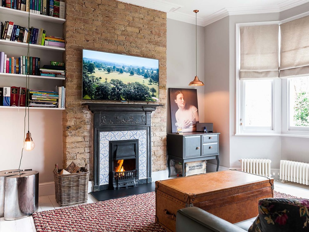 Inspiration for a large transitional formal and enclosed painted wood floor living room remodel in London with gray walls, a standard fireplace, a tile fireplace and a wall-mounted tv