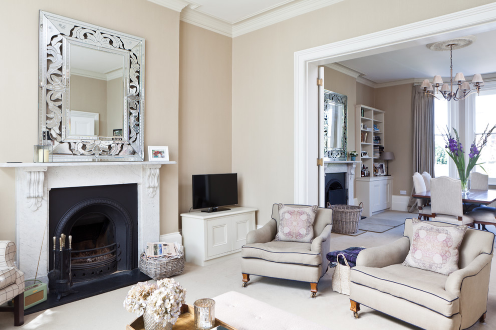 Photo of a victorian formal open plan living room in Kent with beige walls, carpet, a standard fireplace and a freestanding tv.