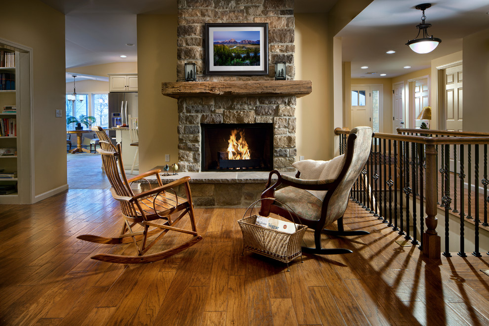 Small elegant formal and open concept medium tone wood floor and brown floor living room photo in Other with beige walls, a standard fireplace, a stone fireplace and no tv