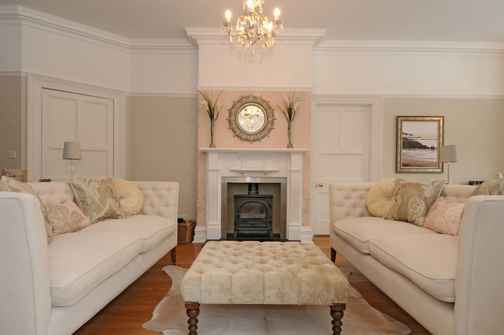 Large traditional formal enclosed living room in Berkshire with no tv, beige walls, medium hardwood flooring, a standard fireplace and a wooden fireplace surround.