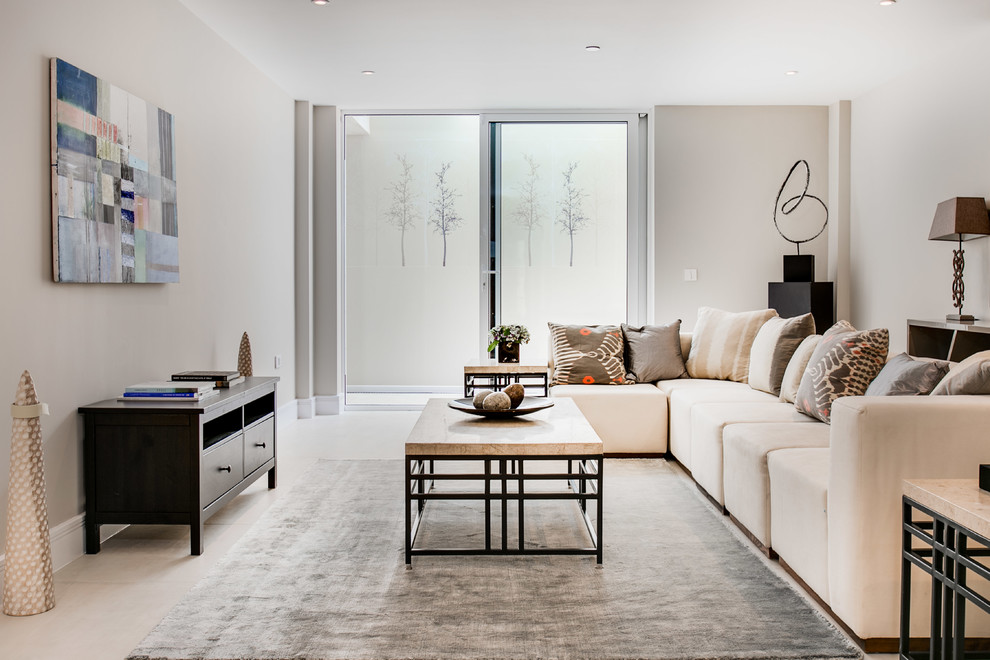 Example of a transitional living room design in London with beige walls