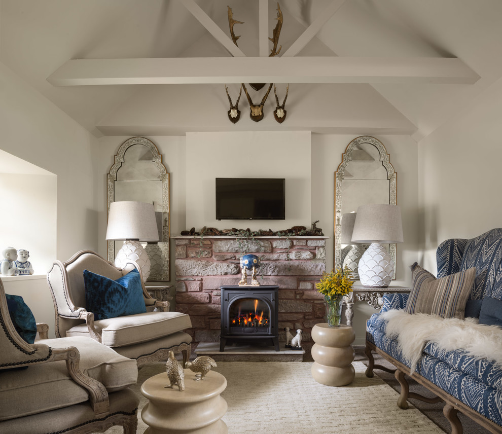 Example of a mid-sized trendy formal living room design in Edinburgh with a wood stove, a stone fireplace and a wall-mounted tv