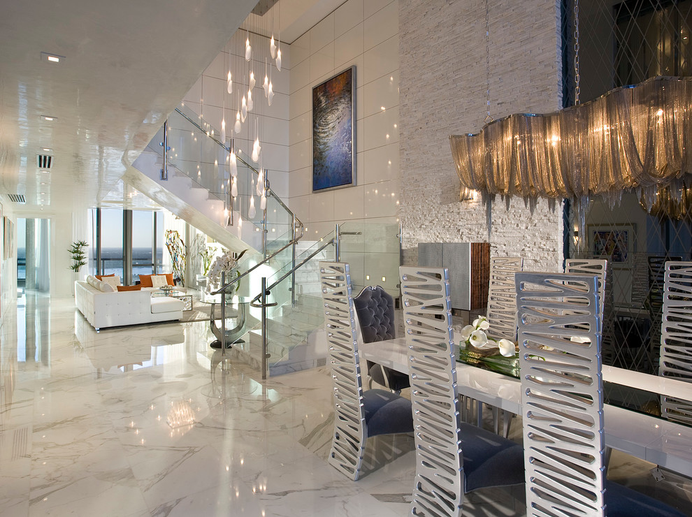 Large contemporary formal open plan living room in Miami with white walls and marble flooring.