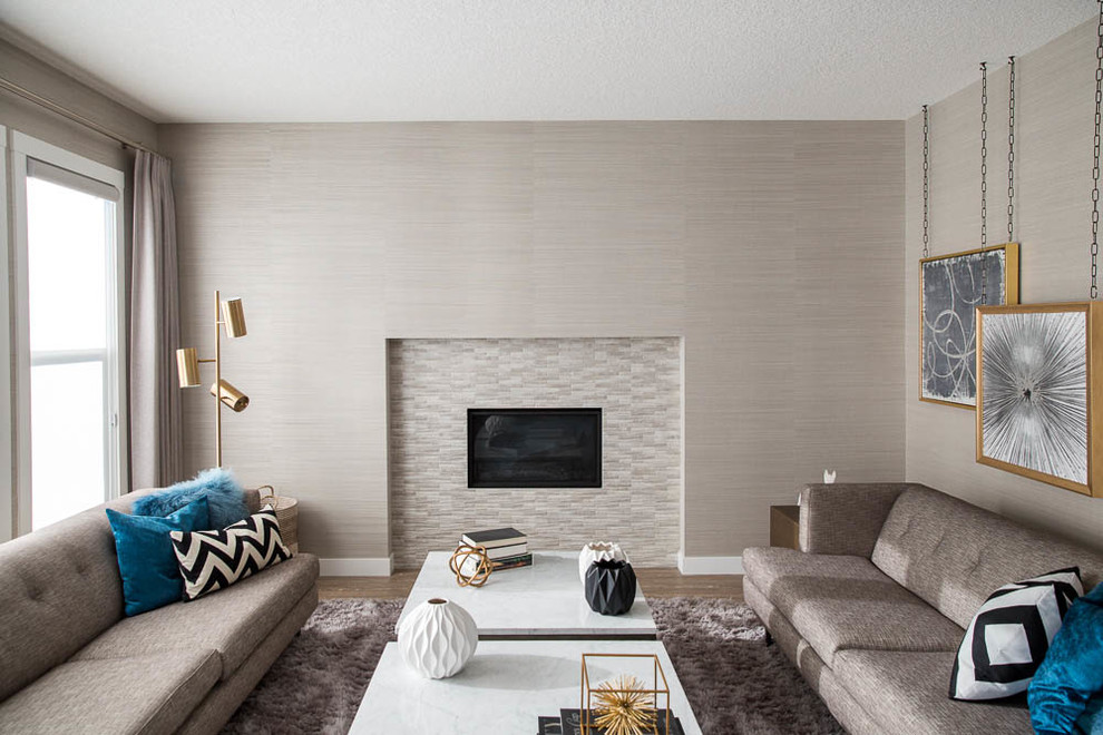 Large modern formal open plan living room in Vancouver with grey walls, medium hardwood flooring, a standard fireplace, a tiled fireplace surround and brown floors.