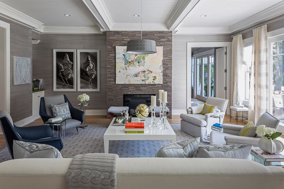Mid-sized transitional enclosed medium tone wood floor living room photo in Other with gray walls, a standard fireplace and a stone fireplace