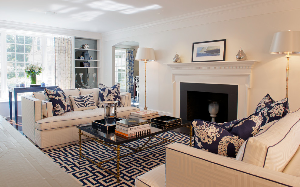 Example of a large beach style enclosed and formal living room design in New York with white walls, a standard fireplace, a plaster fireplace and no tv