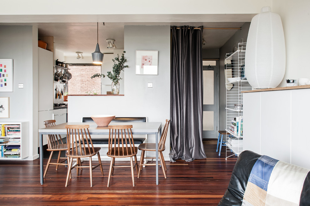 Photo of a contemporary open plan living room curtain in London with dark hardwood flooring.