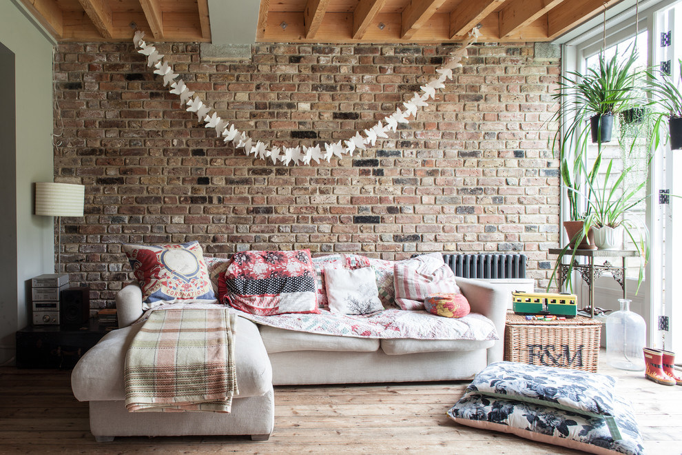 Mid-sized mountain style enclosed light wood floor living room photo in London