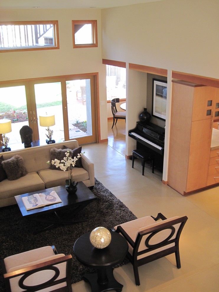 This is an example of a medium sized world-inspired open plan living room in San Francisco with a music area, beige walls, concrete flooring, a standard fireplace, a tiled fireplace surround and a built-in media unit.