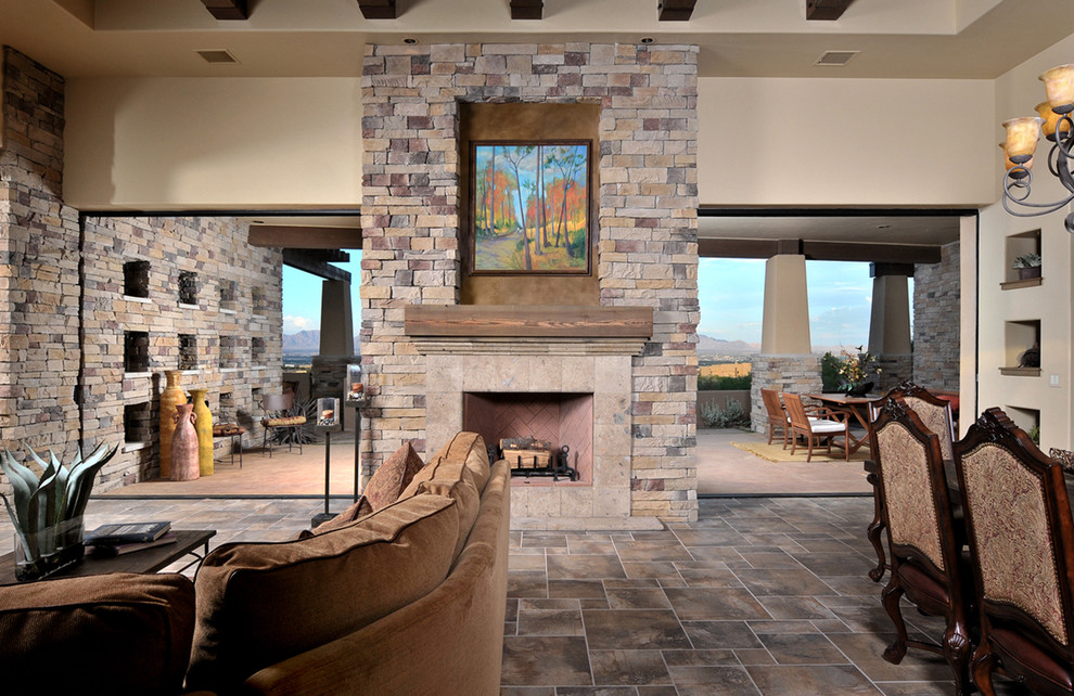 Example of a tuscan living room design in Austin with a stone fireplace