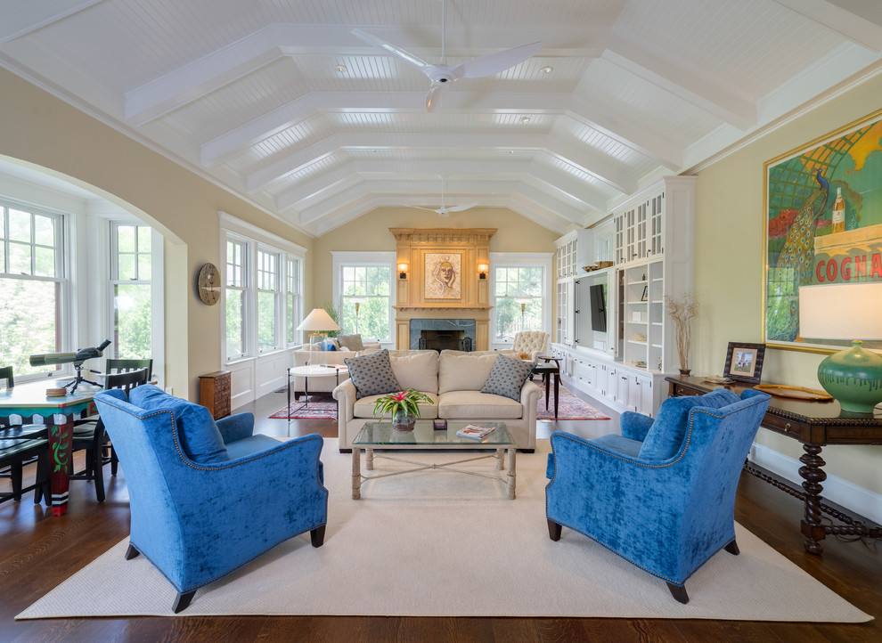 Photo of a classic open plan living room in New York with beige walls, dark hardwood flooring, a standard fireplace and brown floors.