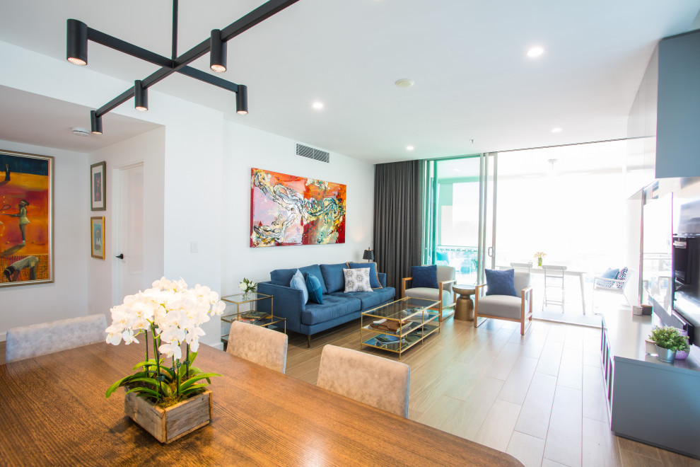 Photo of an expansive modern open plan living room in Brisbane with white walls, porcelain flooring, no tv and brown floors.