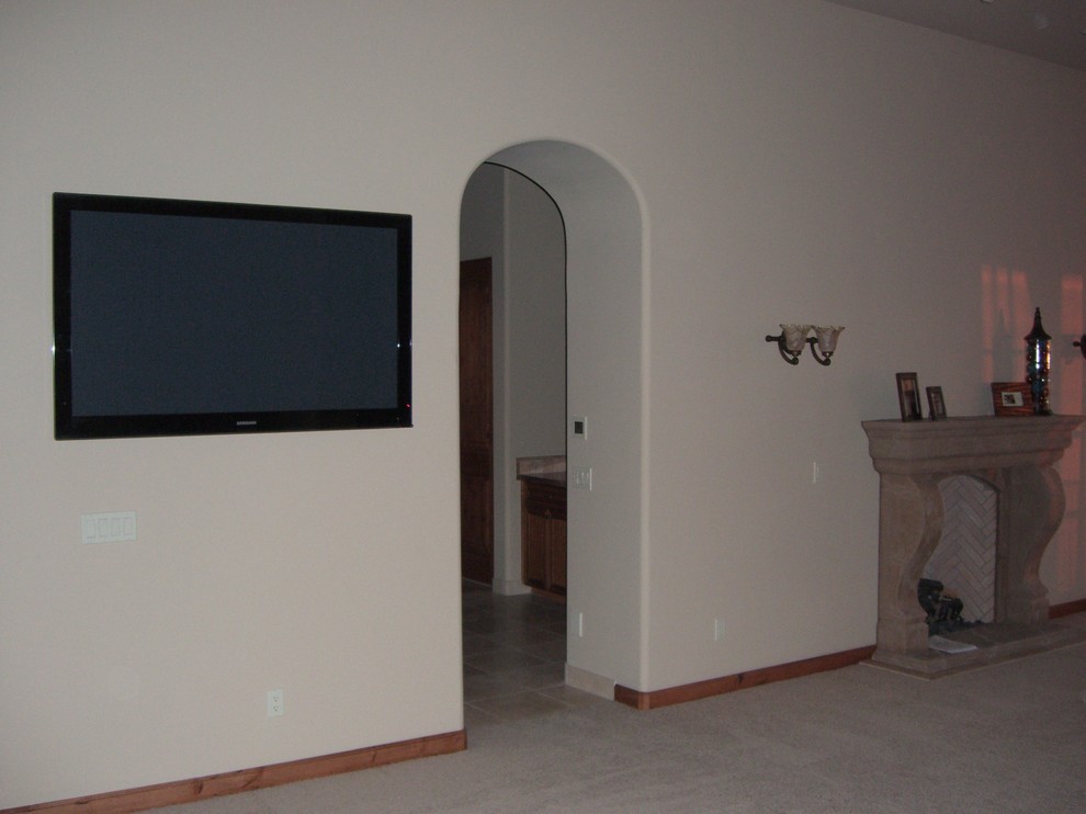 Example of a large southwest open concept ceramic tile living room design in Phoenix with white walls, a standard fireplace, a stone fireplace and a wall-mounted tv