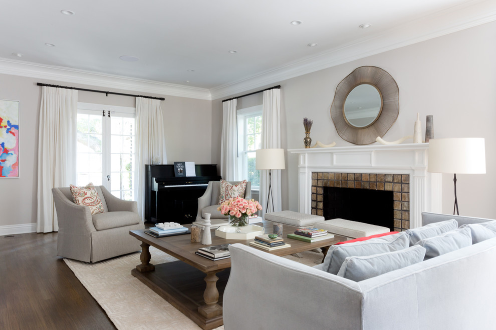 Inspiration for an expansive contemporary living room in Los Angeles with beige walls, dark hardwood flooring, a standard fireplace and a tiled fireplace surround.