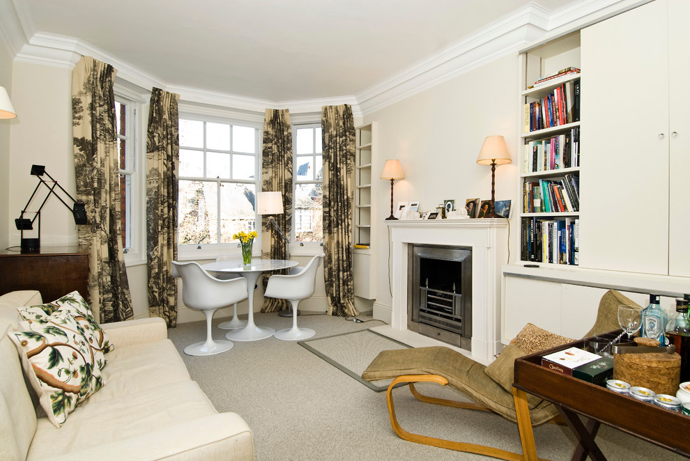 Transitional enclosed carpeted living room library photo in London with beige walls, a standard fireplace and no tv