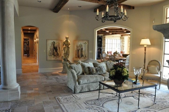 Traditional open plan living room in Little Rock with travertine flooring, a standard fireplace, a stone fireplace surround and no tv.