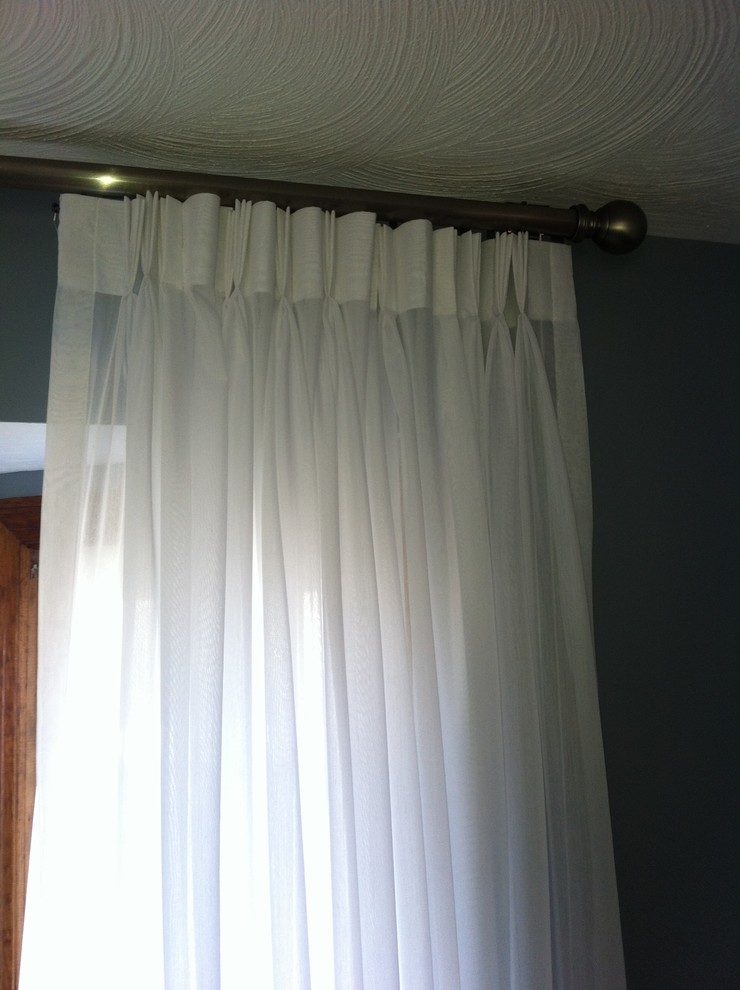 Pinch pleat Sheers on traversing rod Transitional Living Room