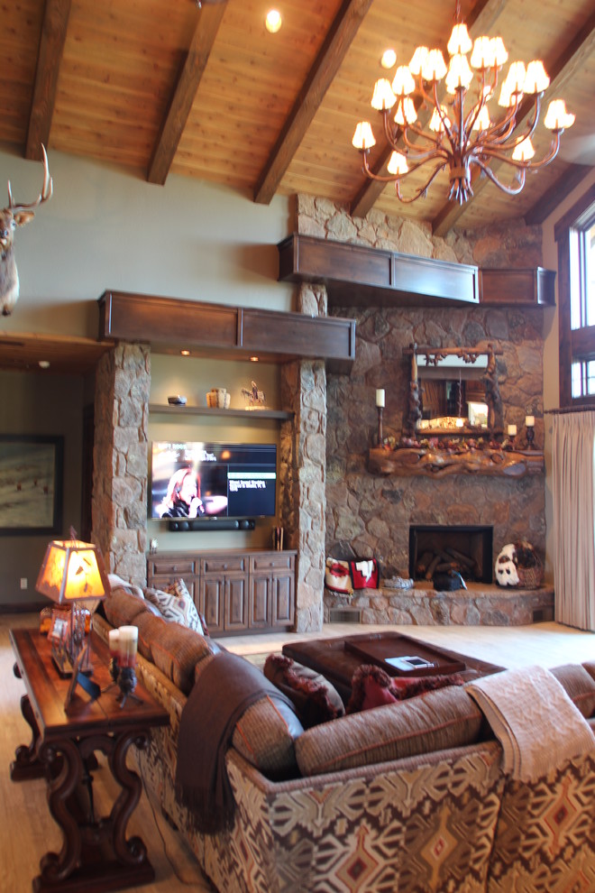 Large rustic formal open plan living room in Phoenix with green walls, carpet, a corner fireplace, a stone fireplace surround and a wall mounted tv.