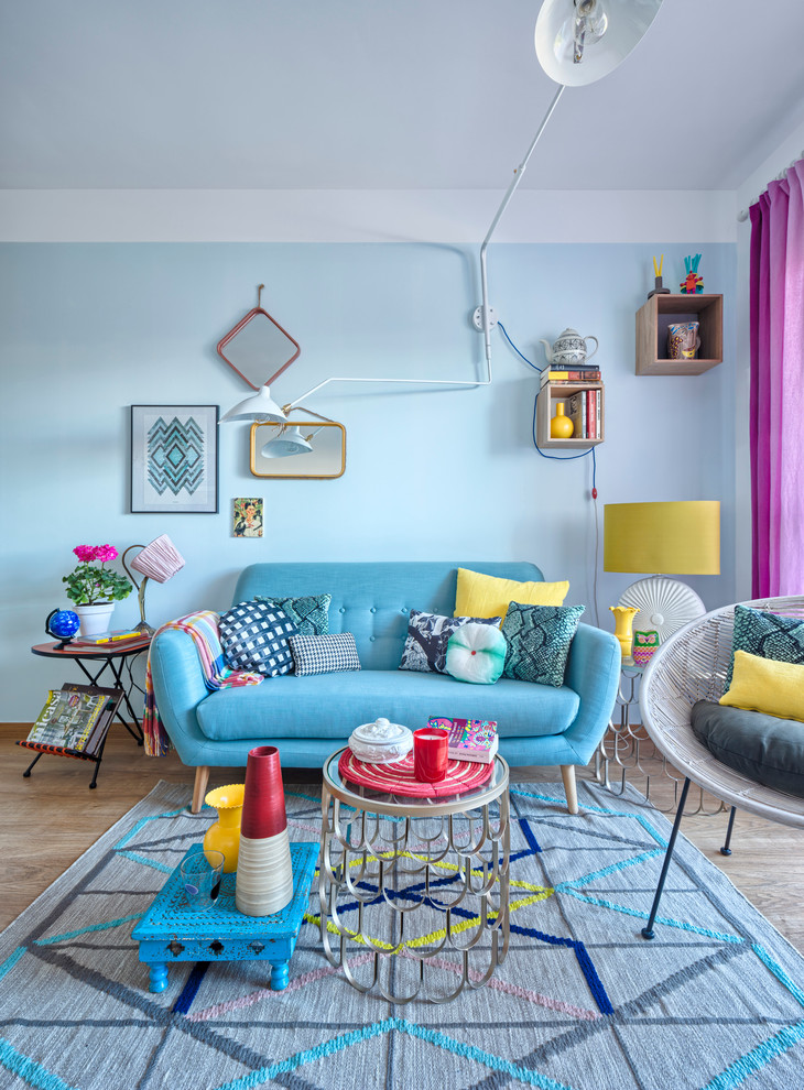 Inspiration for a mid-sized eclectic formal and enclosed light wood floor living room remodel in Malaga with blue walls, no fireplace and no tv