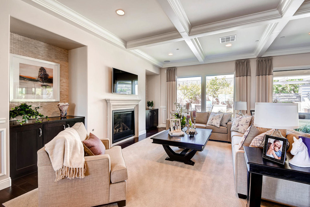 Living room - huge transitional open concept dark wood floor living room idea in Las Vegas with beige walls, a standard fireplace, a wood fireplace surround and a wall-mounted tv