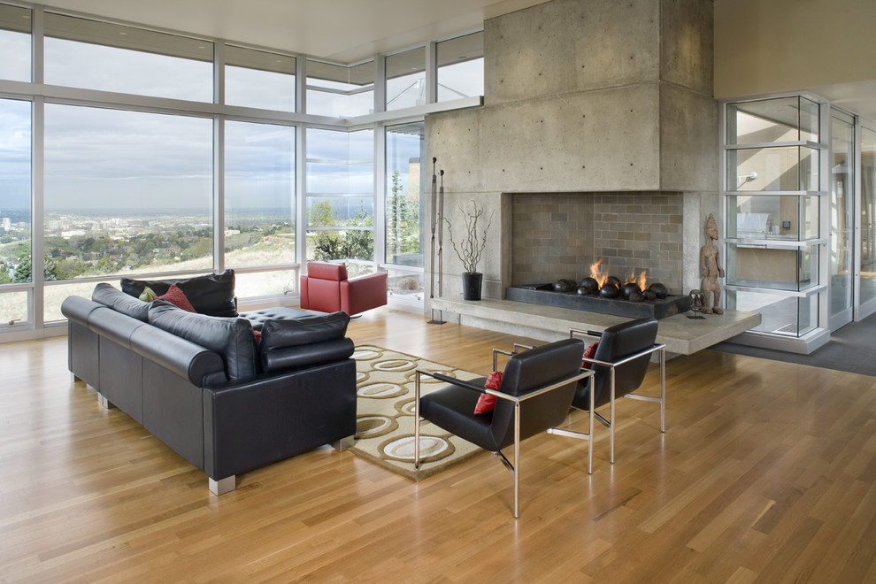 Photo of a contemporary living room in Boise with a concrete fireplace surround.