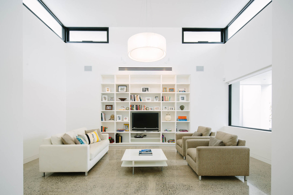 Idée de décoration pour un salon minimaliste de taille moyenne avec un mur blanc et un téléviseur encastré.