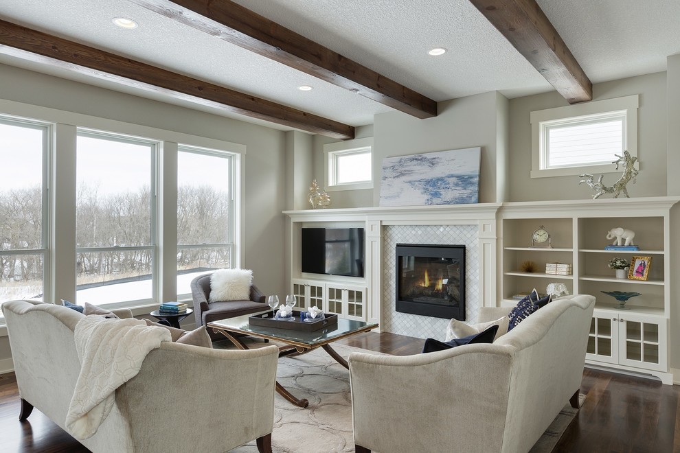 This is an example of a medium sized traditional open plan living room in Minneapolis with grey walls, dark hardwood flooring, a standard fireplace, a tiled fireplace surround and a built-in media unit.