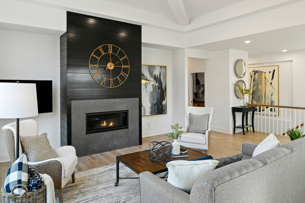 Photo of a medium sized classic formal open plan living room in Minneapolis with white walls, light hardwood flooring, a ribbon fireplace, a timber clad chimney breast, a wall mounted tv and brown floors.